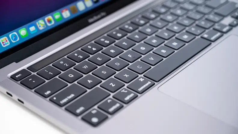 Close-up of a MacBook laptop's keyboard: flat, smooth black keys in an aluminum chassis.