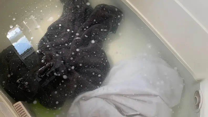 One dark towel and one light towel just put in to a mixture of borax, washing soda, and laundry detergent
