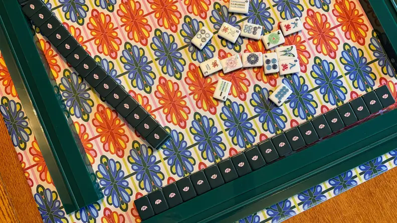 A mat, tiles and rack of Mahjong