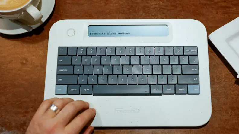 The Freewrite Alpha being used in a coffee shop.
