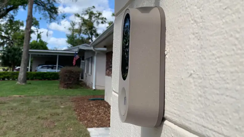 Nooie Doorbell Cam hanging on a house