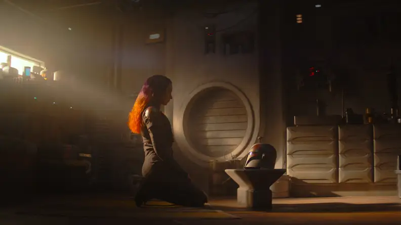 Sabine Wren looking at her helmet
