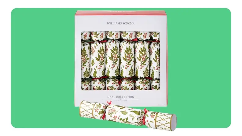A box of Williams Sonoma Christmas crackers in front of green background.