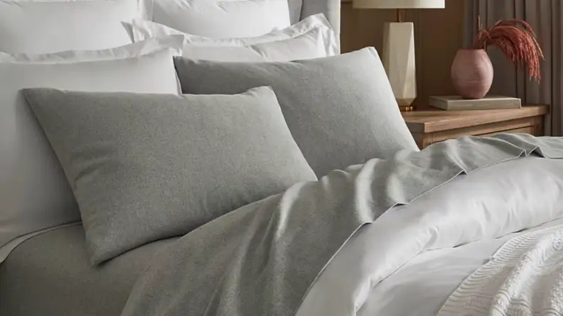 An image of a gray set of Boll and Branch flannel sheets arranged on a bed.