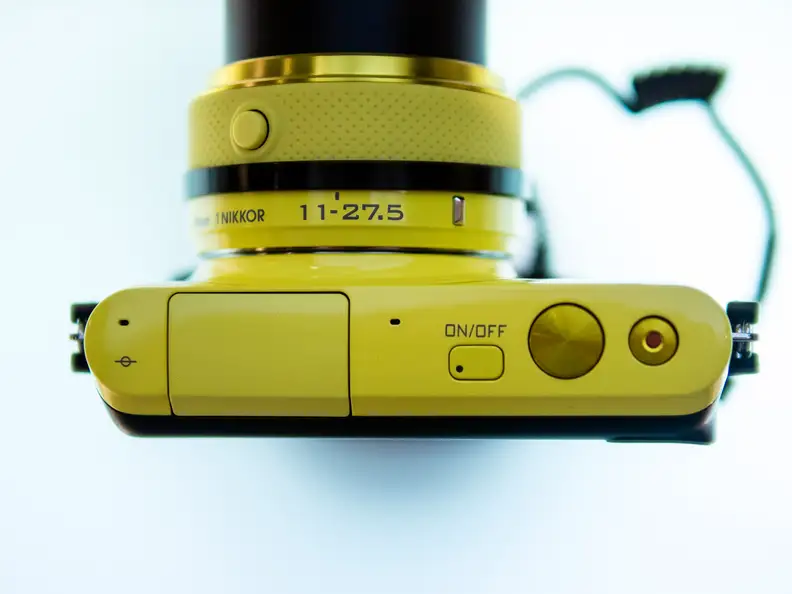 The Nikon 1 S2 comes in yellow, red, black, or white.