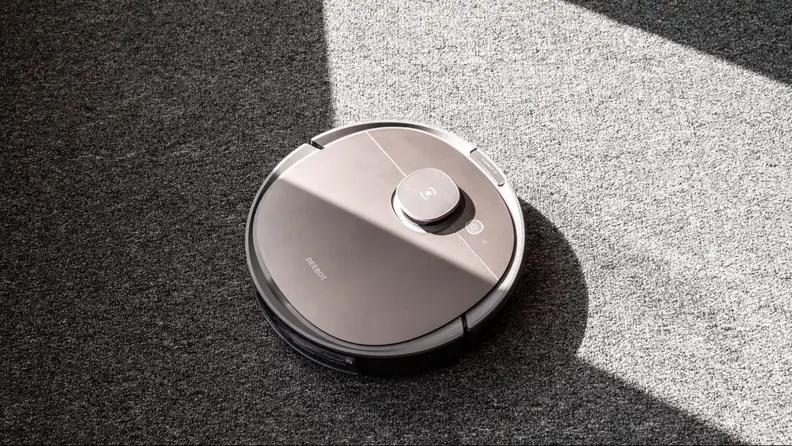 Ecovacs Deebot T8 vacuuming a sunlit room.