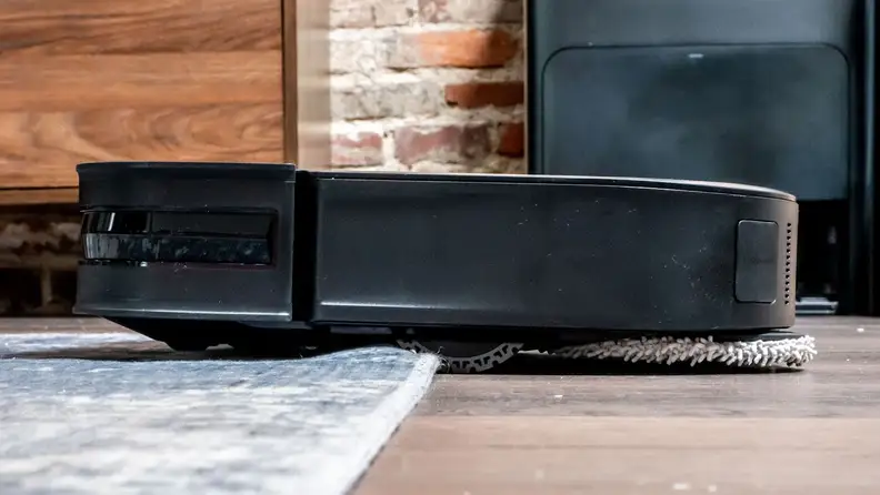 The Ecovacs Deebot X2 Combo transitioning from cleaning hardwood to carpet.
