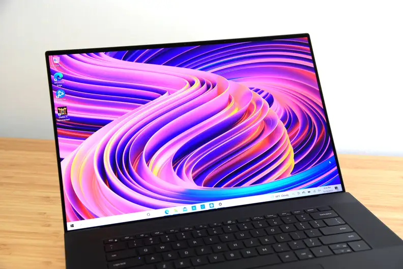 A laptop display turned on and showing off a colorful wallpaper
