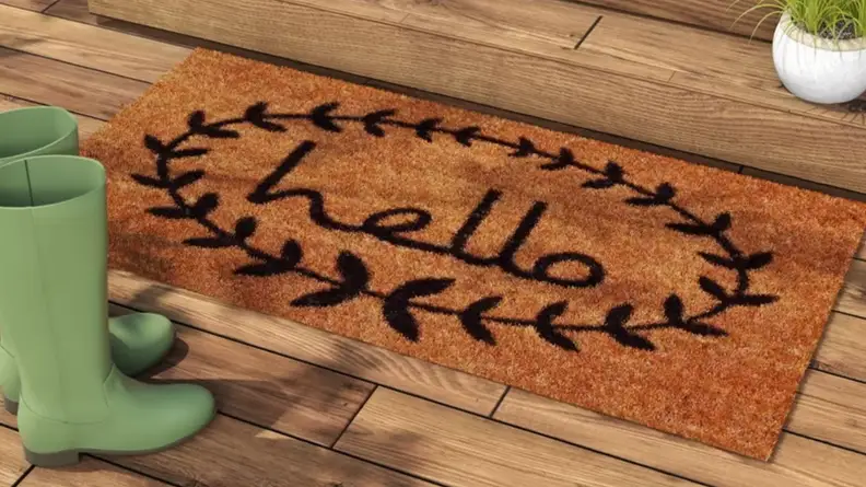Welcome mat in front of a door with the word "hello" on it