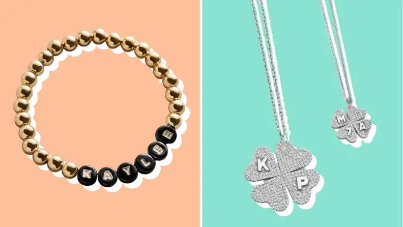 A gold beaded bracelet with personalized letter beads next to silver pavé clover pendant necklaces with initials.