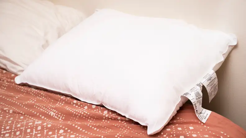 the AmazonBasics soft density pillow on a bed