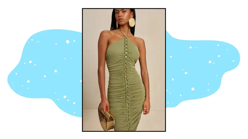 A model wearing a green halter dress with metallic gold details.