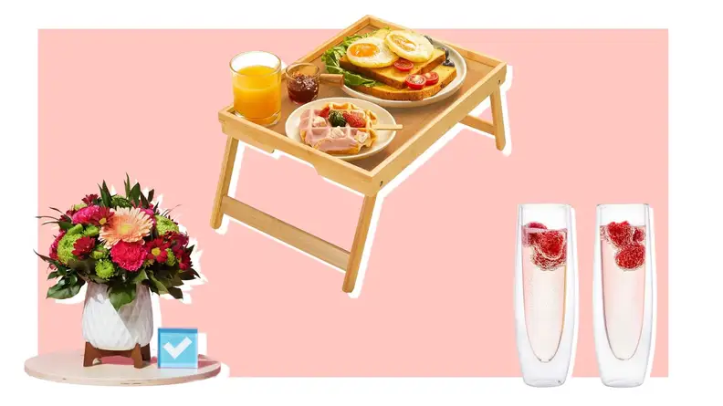 Potted flowers next to bamboo bed tray and stemless champagne flutes.