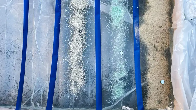 Sand, ice melt, and kitty litter spread out on ice