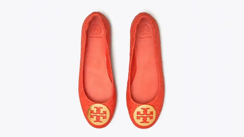Red shoes with iconic Tory Burch golden toe medallion