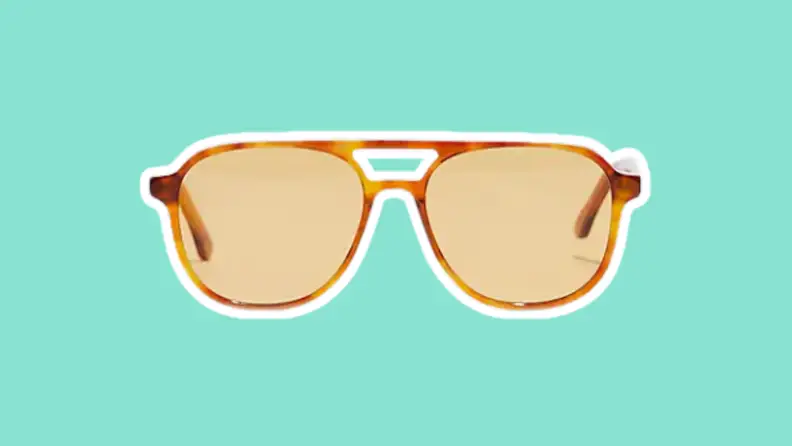 The Madewell Acetate Linford Aviator Sunglasses on a green background.