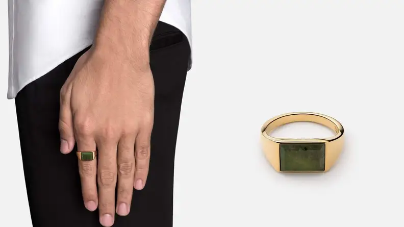 man wearing ring with hand rested to his side, gold ring with stone