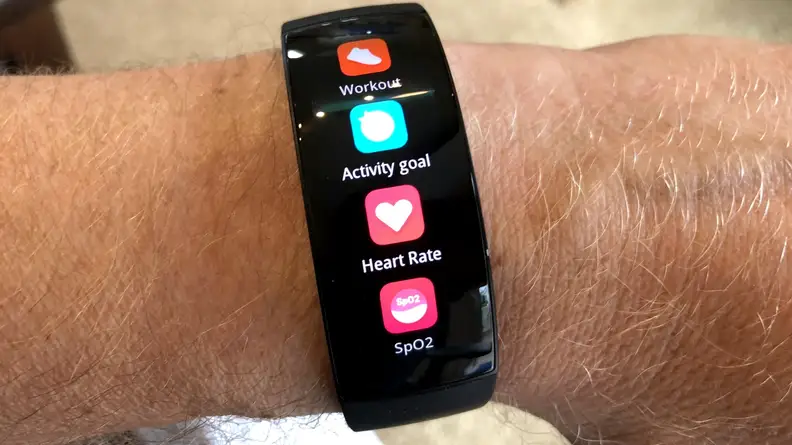 The all-black Amazfit X is shown on a wrist with multiple exercise apps glowing in vivid color across its curved OLED display.