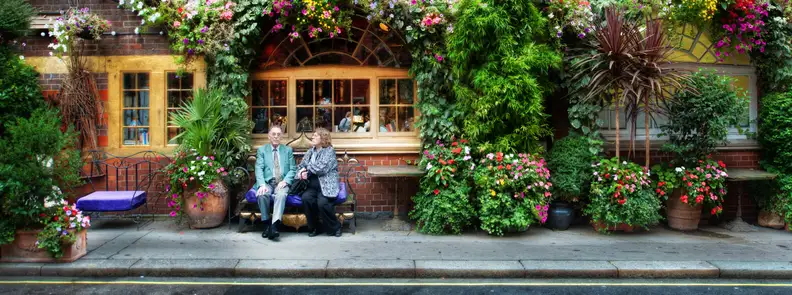 A couple waiting outside a restaurant.