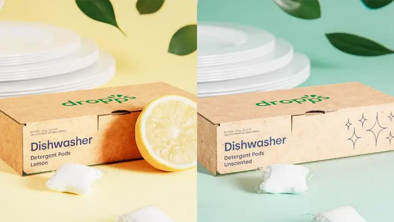 Left: A cardboard box of dishwasher detergent pods in a lemon scent, surrounded by a fresh lemon and a stack of clean white plates. Right: A cardboard box of unscented dishwasher detergent pods surrounded by a stack of clean white plates.