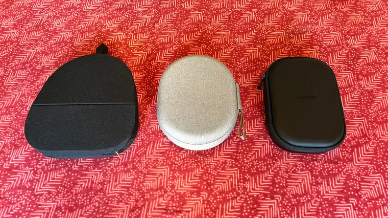 The Sony Wh-1000XM5, XM4, and Bose QC45 sit inside their cases on a red table cloth.