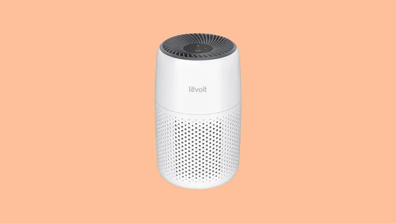 A white Levoit Core mini against a light orange background.