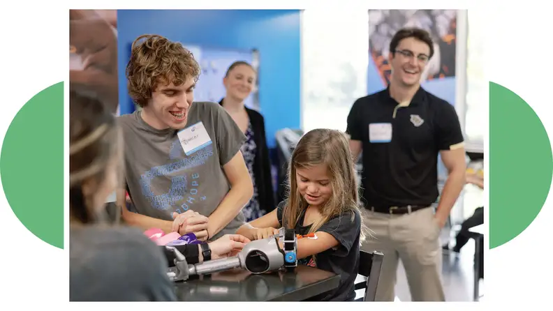 A young girl wears a prosthetic arm from Limbitless Solutions, which offers affordable access to the technology.
