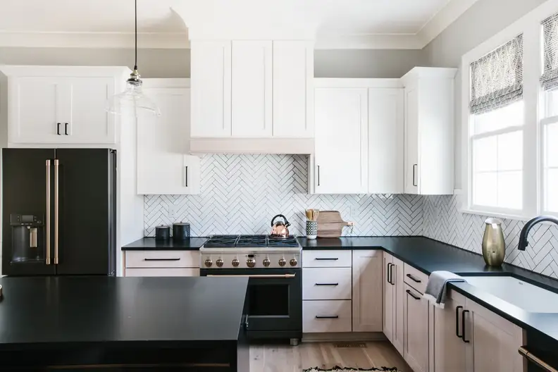 The Matte Black refrigerator and range coordinate with the black countertop