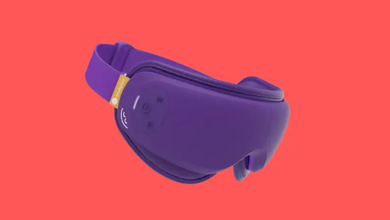 A purple eye mask sits on a red background