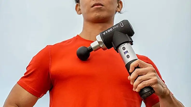 Image of person using massage gun device