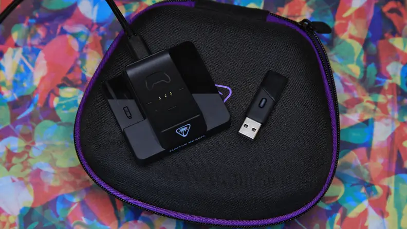 The charging station and the USB dongle laying down flat.