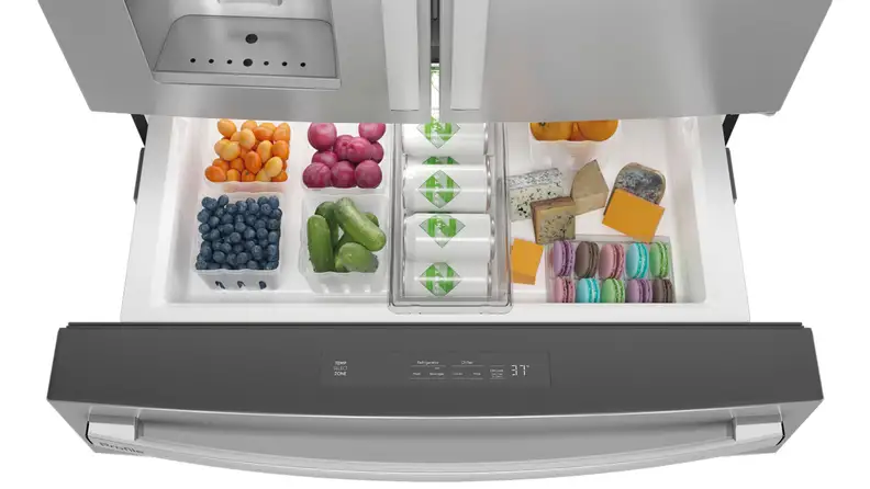 A shot of the GE Profile PVD28BYNFS four door French door refrigerator's flex drawer, open, as seen from above, full of groceries.