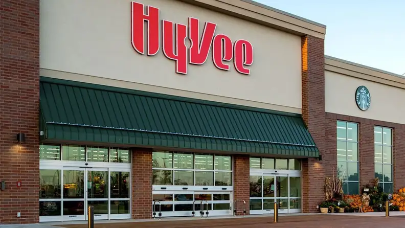 Hy-Vee storefront entrance with Starbucks signage and pumpkin display