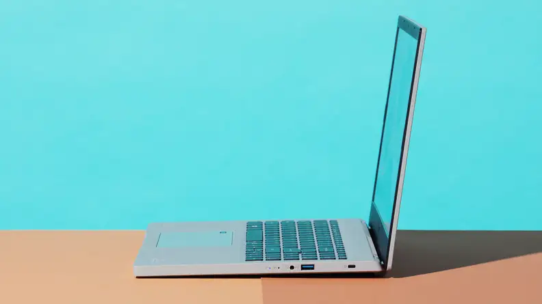 A side view of the Acer Apsire Vero laptop on a baby blue background.
