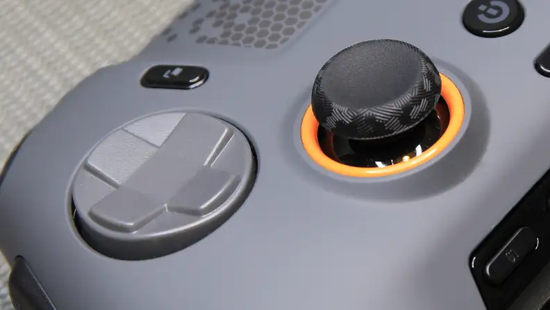 Close up shot of the black thumb stick and gray directional pad on the gray Scuf Envision Pro gaming controller.