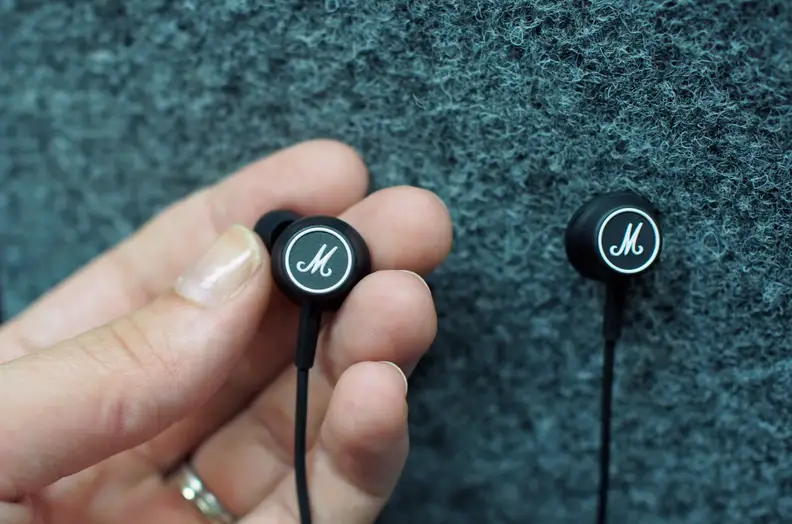 The Marshall Mode in-ear headphones sport white brass lettering on the speaker backs.