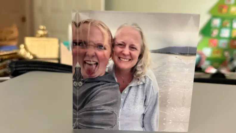 Two women are pictured in an acrylic block