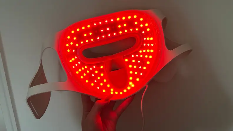 Megelin LASER & LED Mask shown lit up red and functioning.