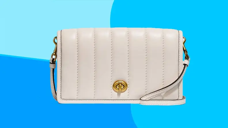 White leather crossbody bag on a blue background