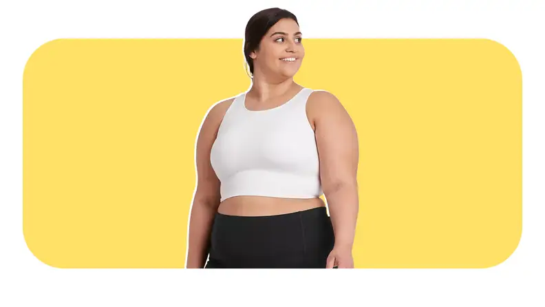 Model smiling while wearing white compression tank top and leggings from Target