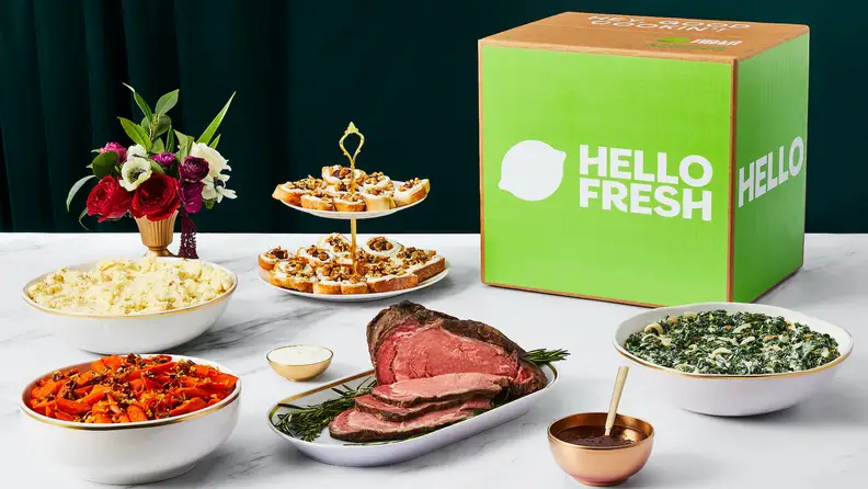 Prime rib and sides on a table with a HelloFresh box.