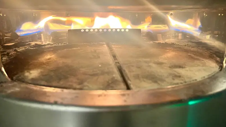 Close up shot of the inside of the Solo Pi Prime oven with open flames.