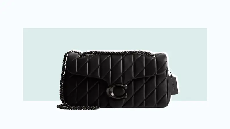 A black quilted leather bag with the Coach C-logo hardware and a chain strap.