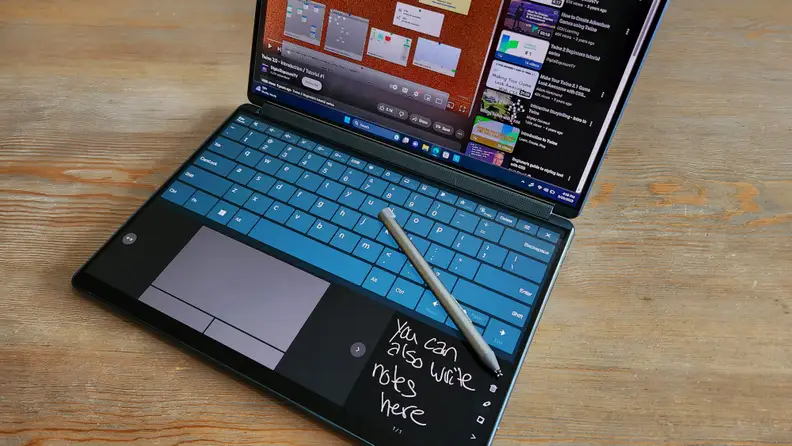 A dual-screen laptop with a virtual keyboard and trackpad.