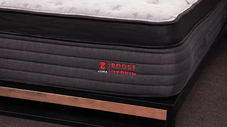 The front edge of the Zoma Boost Hybrid mattress.
