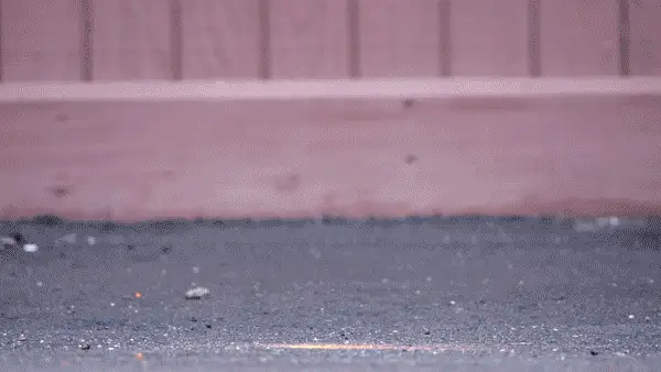 Several padlocks falling from the sky and slamming into asphalt as part of a durability test
