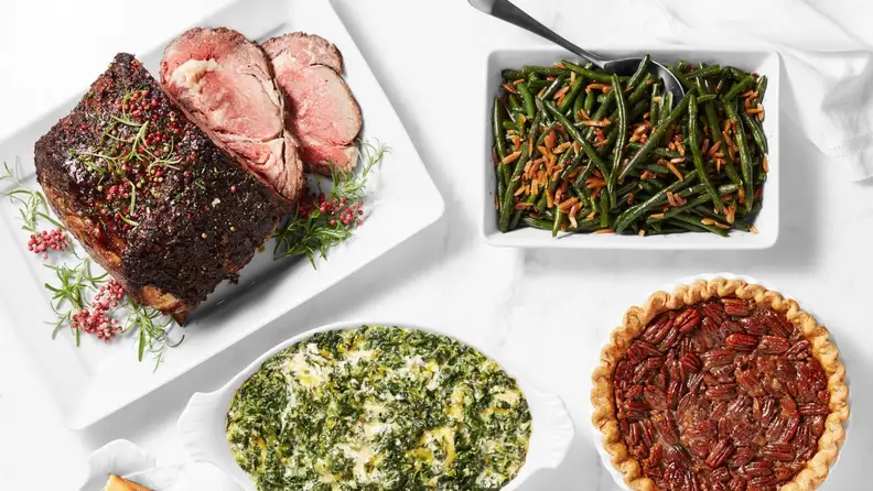 A holiday spread with pot roast, side dishes, and pecan pie