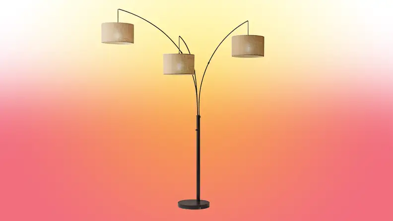A lamp stands on a red and yellow fade background
