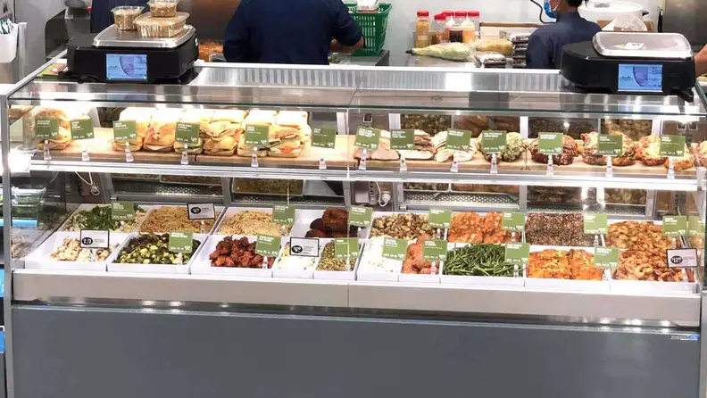 Deli case with prepared sandwiches and sides