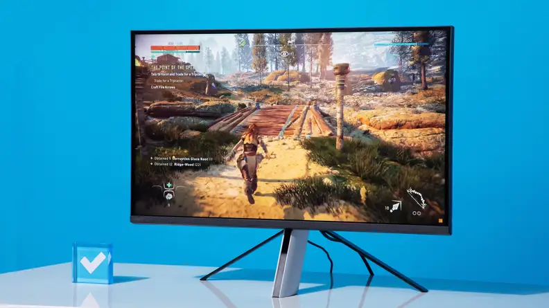 A computer monitor standing on a white desk against a blue background.
